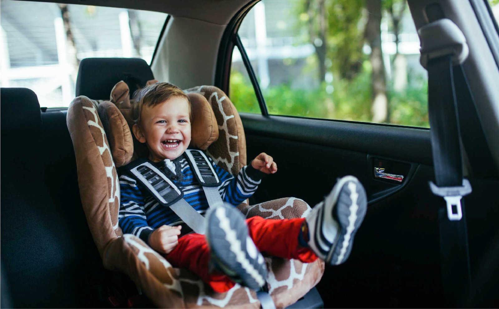 Toddler in a baby seat inside a taxi